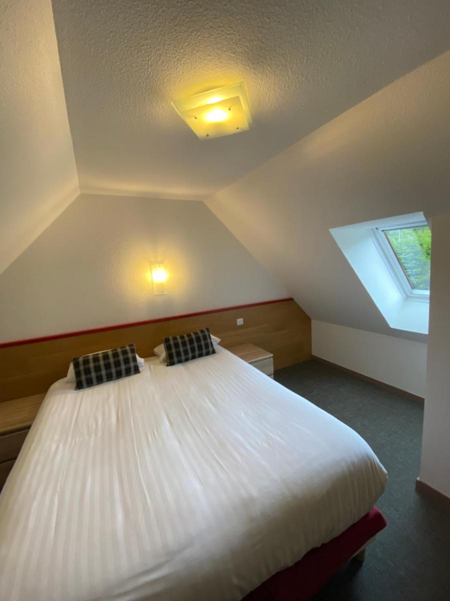 Un ou plusieurs lits dans un hébergement de l'établissement Sancy Resort