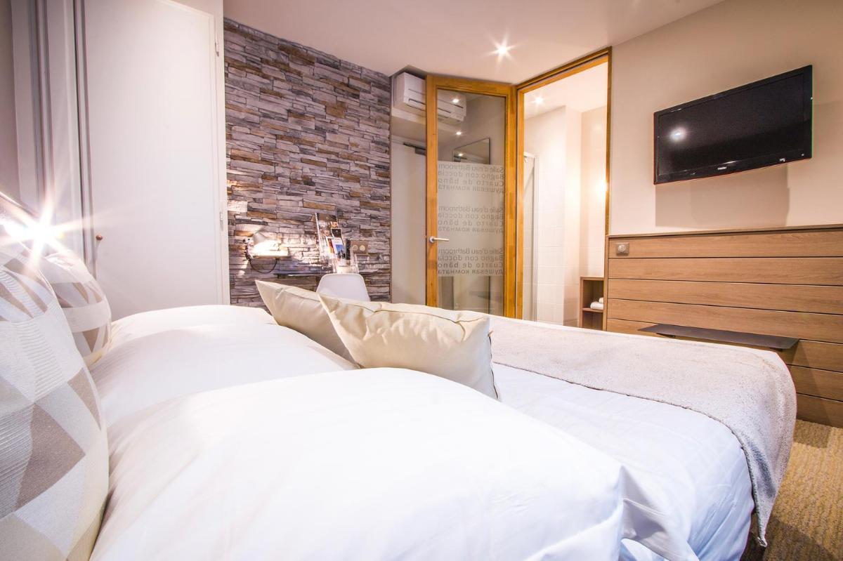 Un ou plusieurs lits dans un hébergement de l'établissement Hôtel des Princes, Chambéry Centre