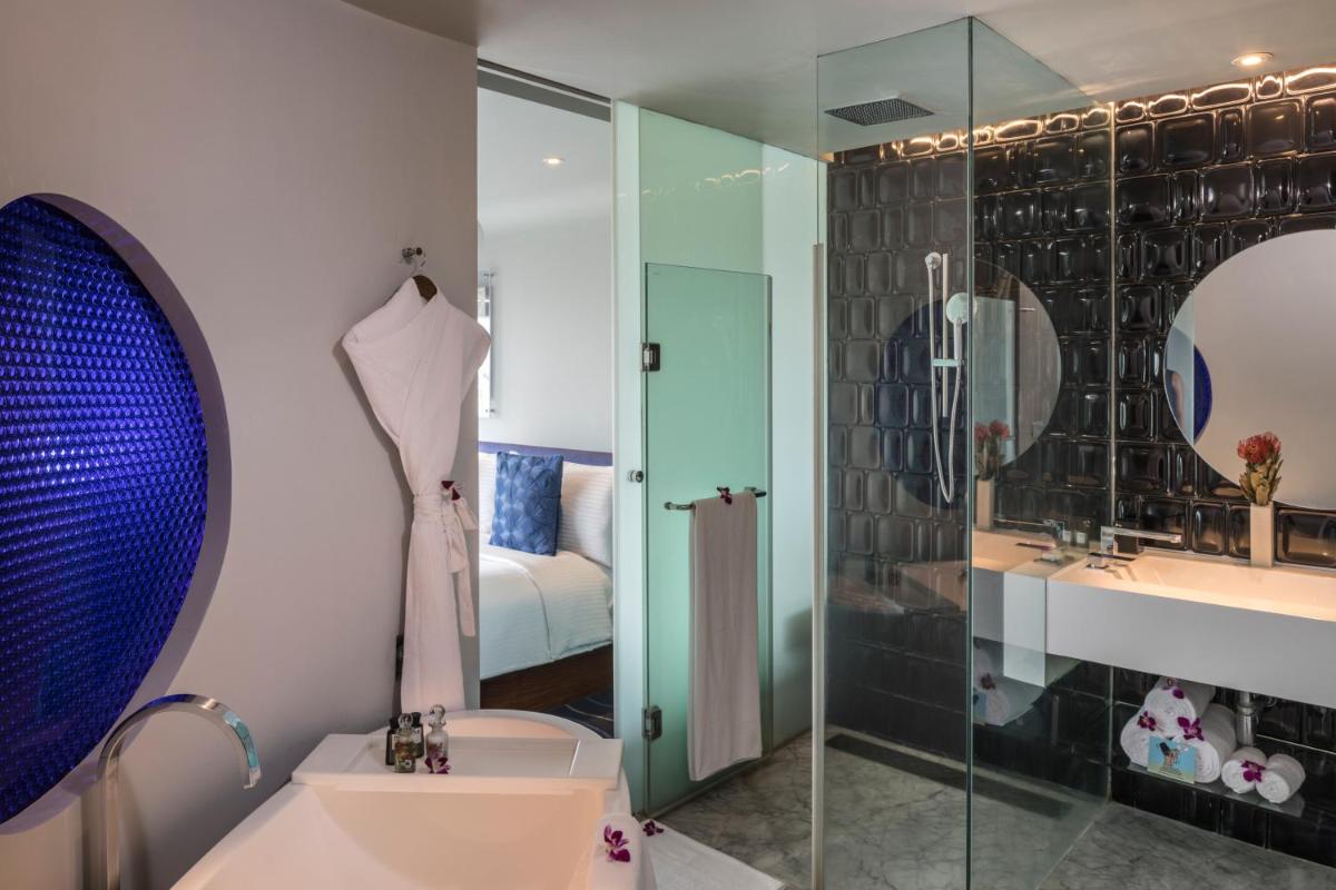 a bathroom with a shower and a sink and a toilet at The Park Hyderabad, Banjara Hills near Hussain Sagar Lake in Hyderabad a bathroom with a shower and a sink and a toilet at The Park Hyderabad, Banjara Hills near Hussain Sagar Lake in Hyderabad