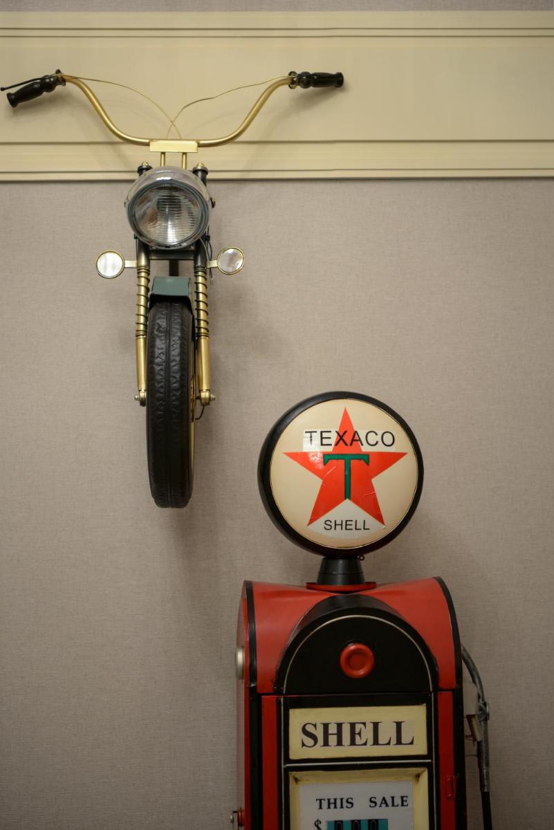 a motorcycle hanging on a wall next to a sign at The Residency Towers Puducherry in Puducherry