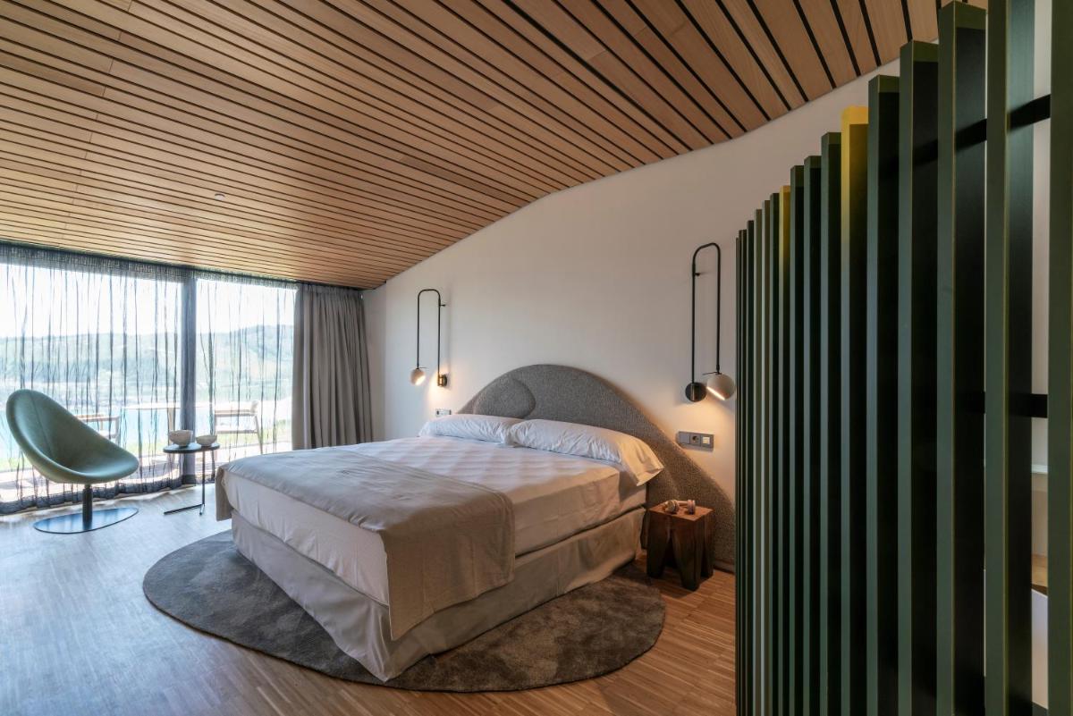 Un dormitorio con una cama y una ventana grande. en Parador Costa da Morte, en Muxía