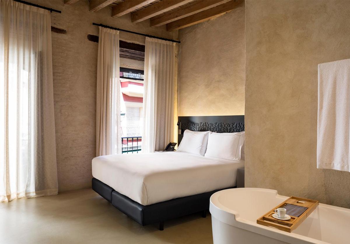 Cama o camas de una habitación en EME Catedral Mercer Hotel