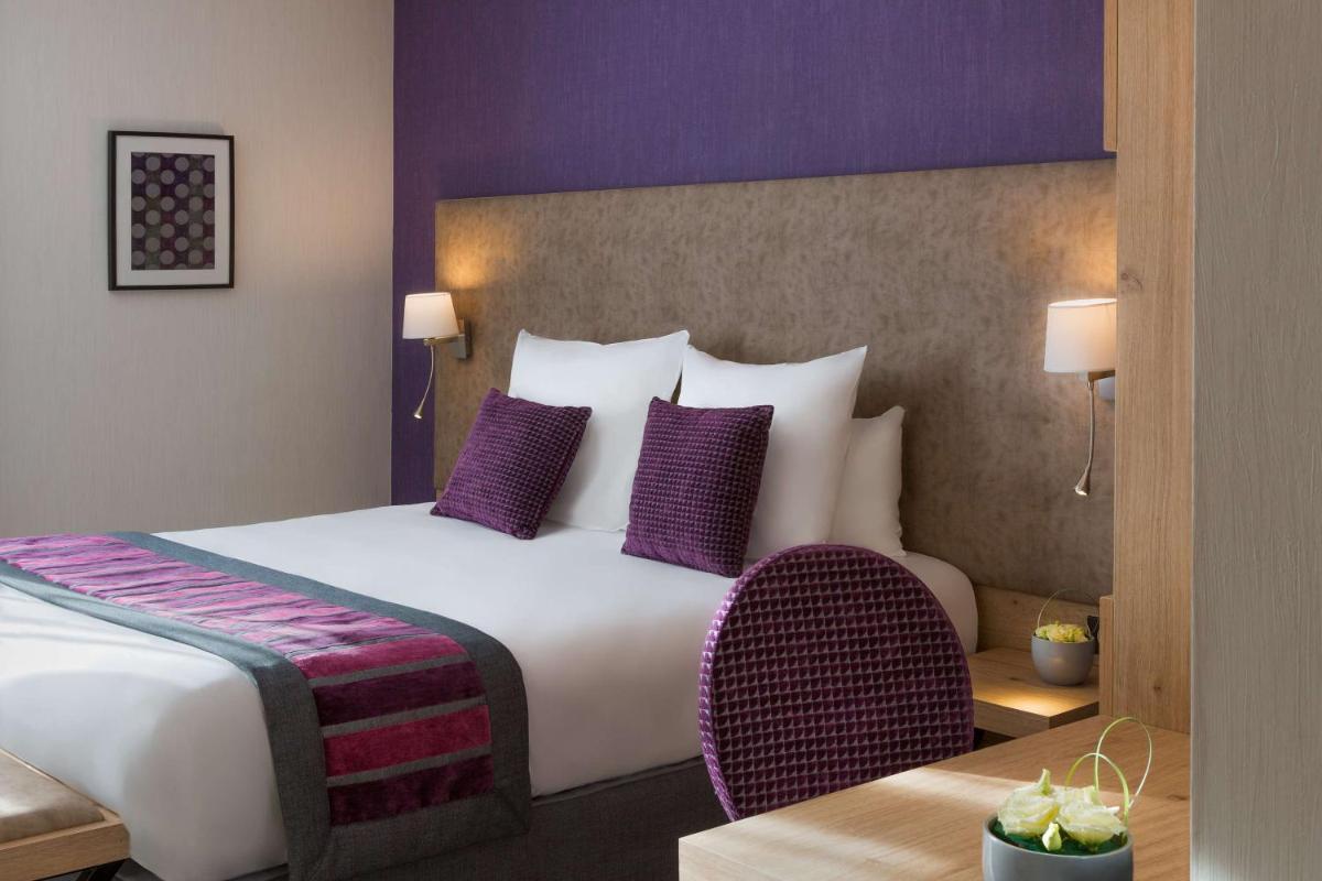 Un ou plusieurs lits dans un hébergement de l'établissement Hôtel Le Rive Droite & SPA