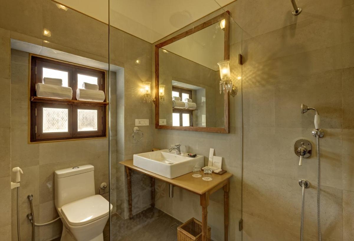 a bathroom with a sink and a toilet and a mirror at Saraca Hotel Lucknow in Lucknow