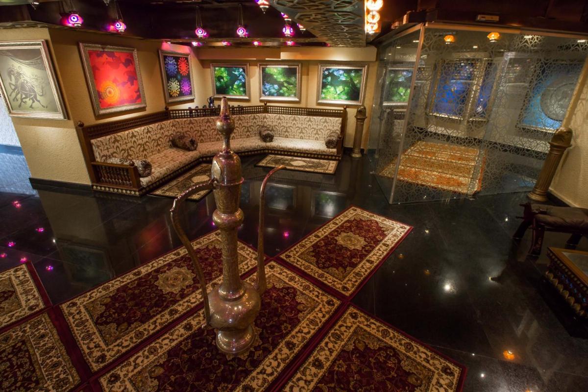 an aerial view of a bathroom with rugs on the floor at Sterlings Mac Hotel in Bengaluru