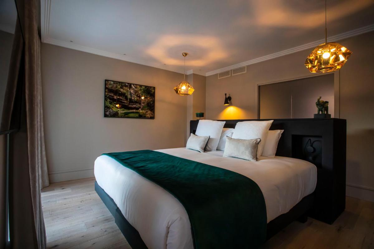 Un ou plusieurs lits dans un hébergement de l'établissement Hôtel L'Incomparable Aix-Les-Bains