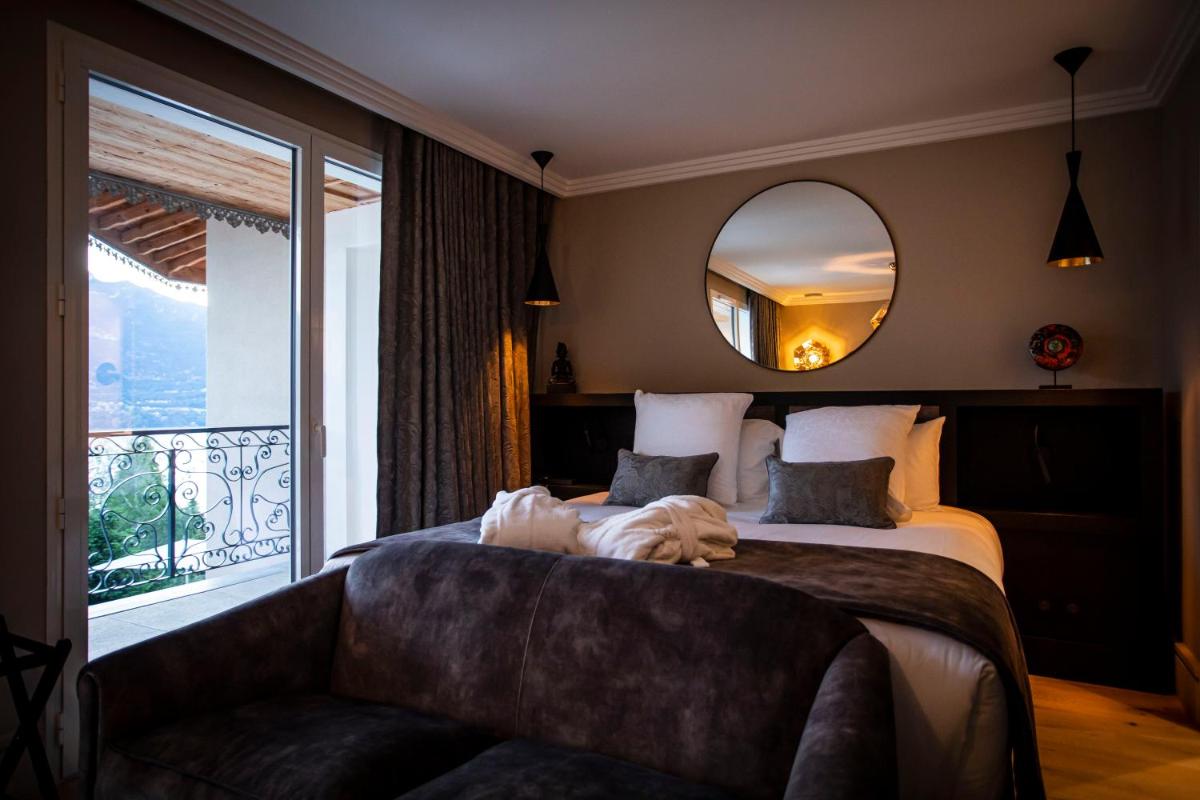 Un ou plusieurs lits dans un hébergement de l'établissement Hôtel L'Incomparable Aix-Les-Bains
