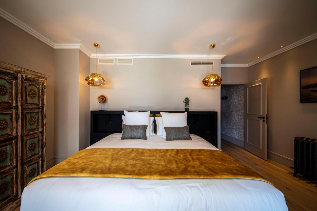 Un ou plusieurs lits dans un hébergement de l'établissement Hôtel L'Incomparable Aix-Les-Bains