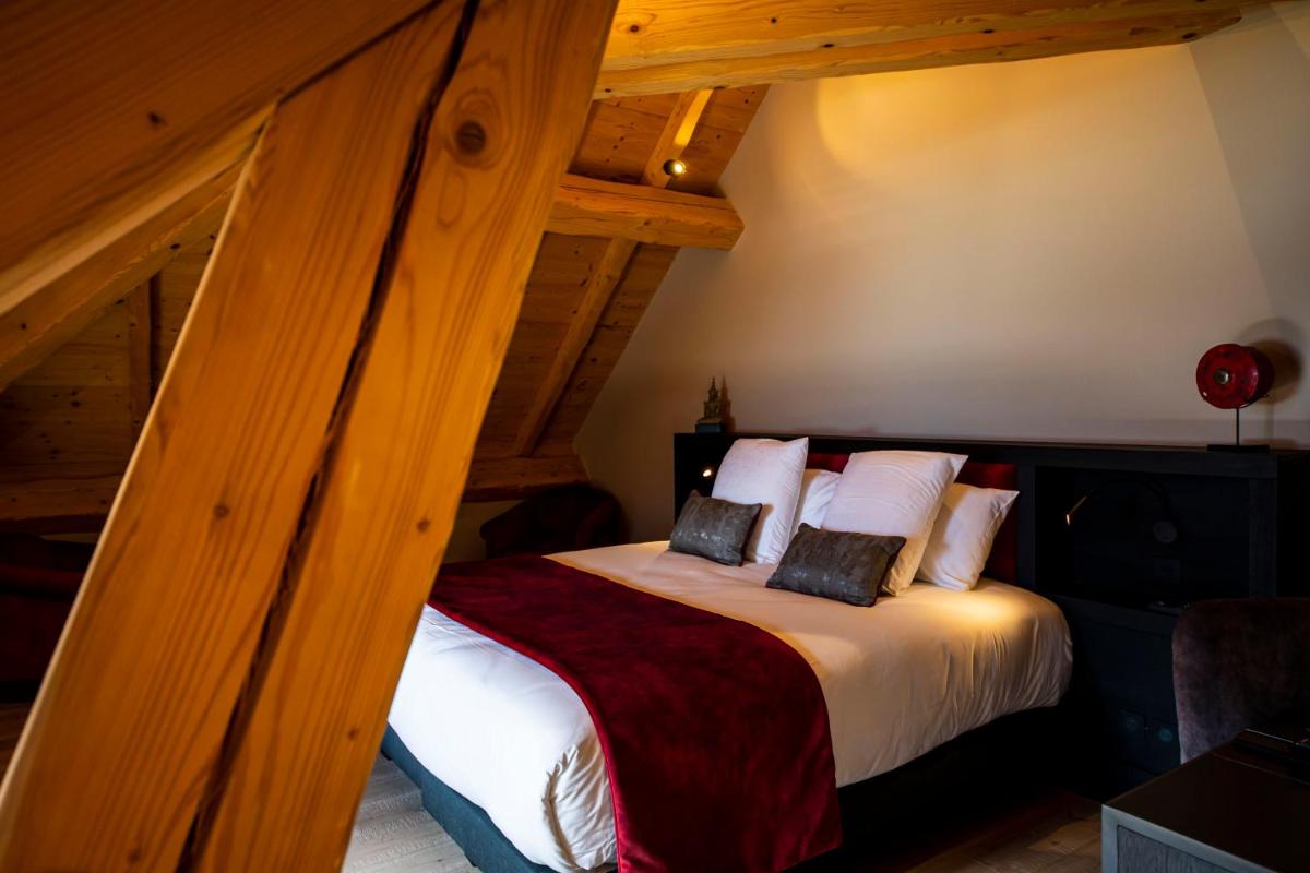 Un ou plusieurs lits dans un hébergement de l'établissement Hôtel L'Incomparable Aix-Les-Bains