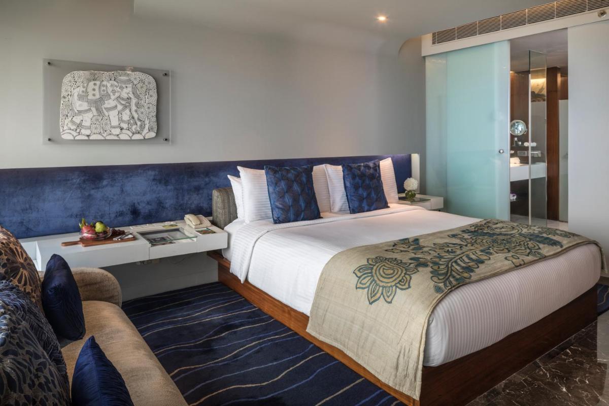 a bedroom with a king sized bed and a living room at The Park Hyderabad, Banjara Hills near Hussain Sagar Lake in Hyderabad a bedroom with a king sized bed and a living room at The Park Hyderabad, Banjara Hills near Hussain Sagar Lake in Hyderabad