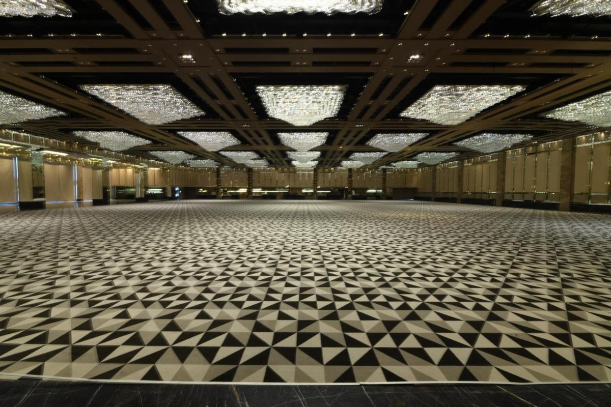 an empty hall with a large room with checkered floors at Wyndham Ahmedabad Shela in Ahmedabad