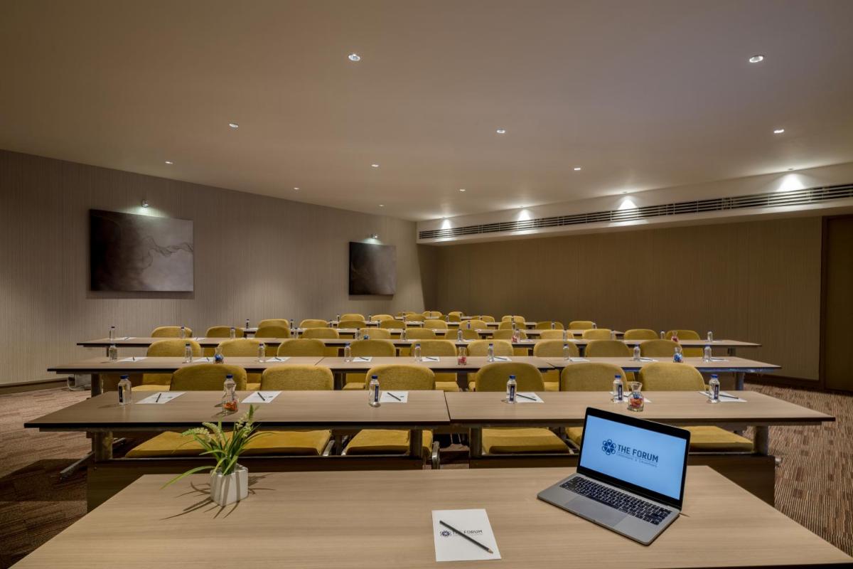 an empty lecture hall with a laptop on a table at Wyndham Ahmedabad Shela in Ahmedabad