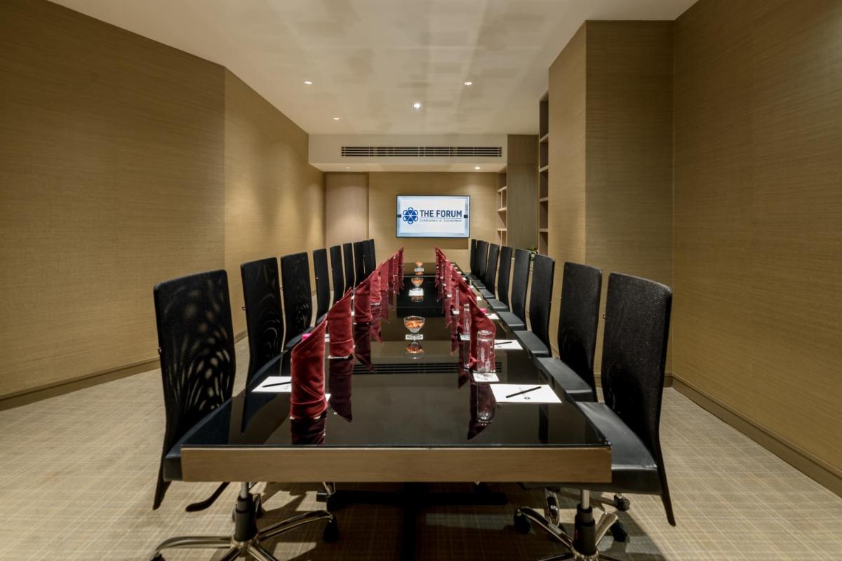 a long conference room with a long table and chairs at Wyndham Ahmedabad Shela in Ahmedabad