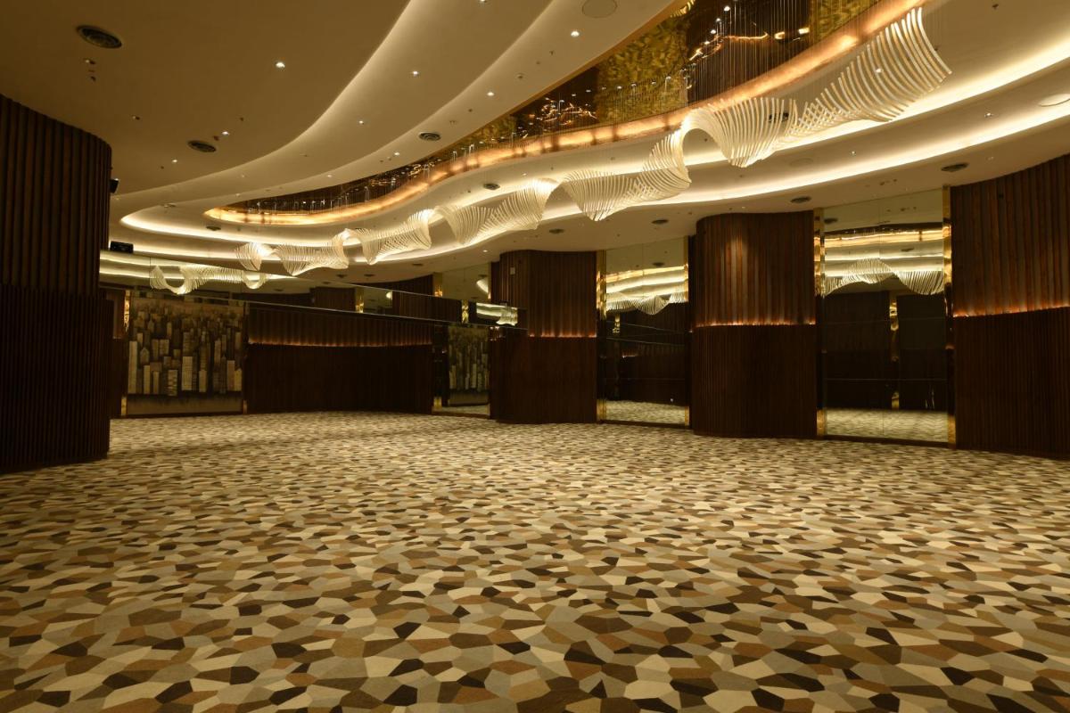 an empty ballroom with a dance floor and lights at Wyndham Ahmedabad Shela in Ahmedabad