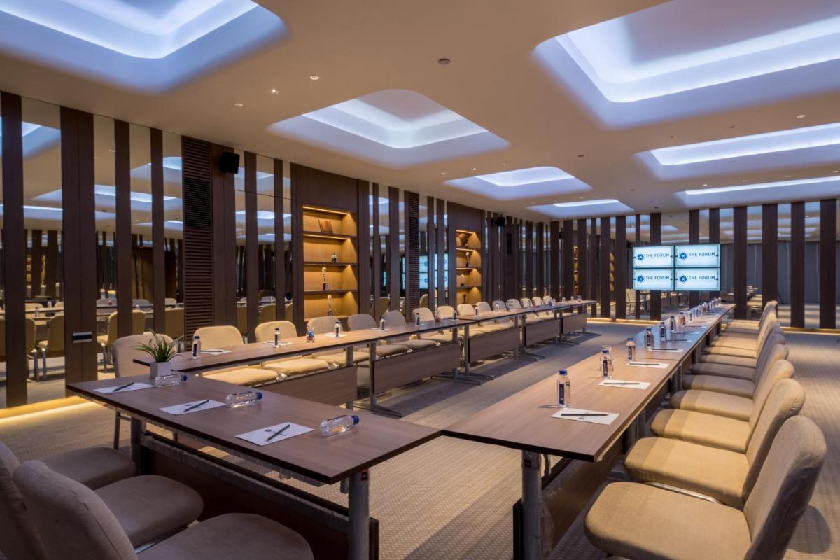 a large dining room with long tables and chairs at Wyndham Ahmedabad Shela in Ahmedabad +96 photos