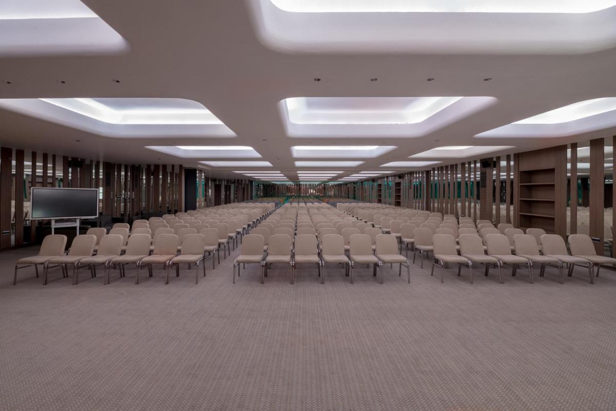 an empty room with rows of chairs in a library at Wyndham Ahmedabad Shela in Ahmedabad