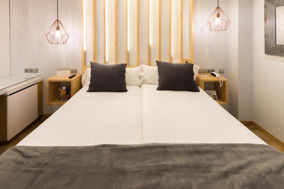 Cama o camas de una habitación en Hotel Fruela