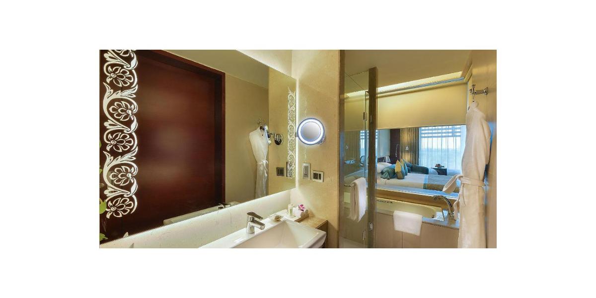 a bathroom with a sink and a mirror at Crowne Plaza Ahmedabad City Centre by IHG in Ahmedabad