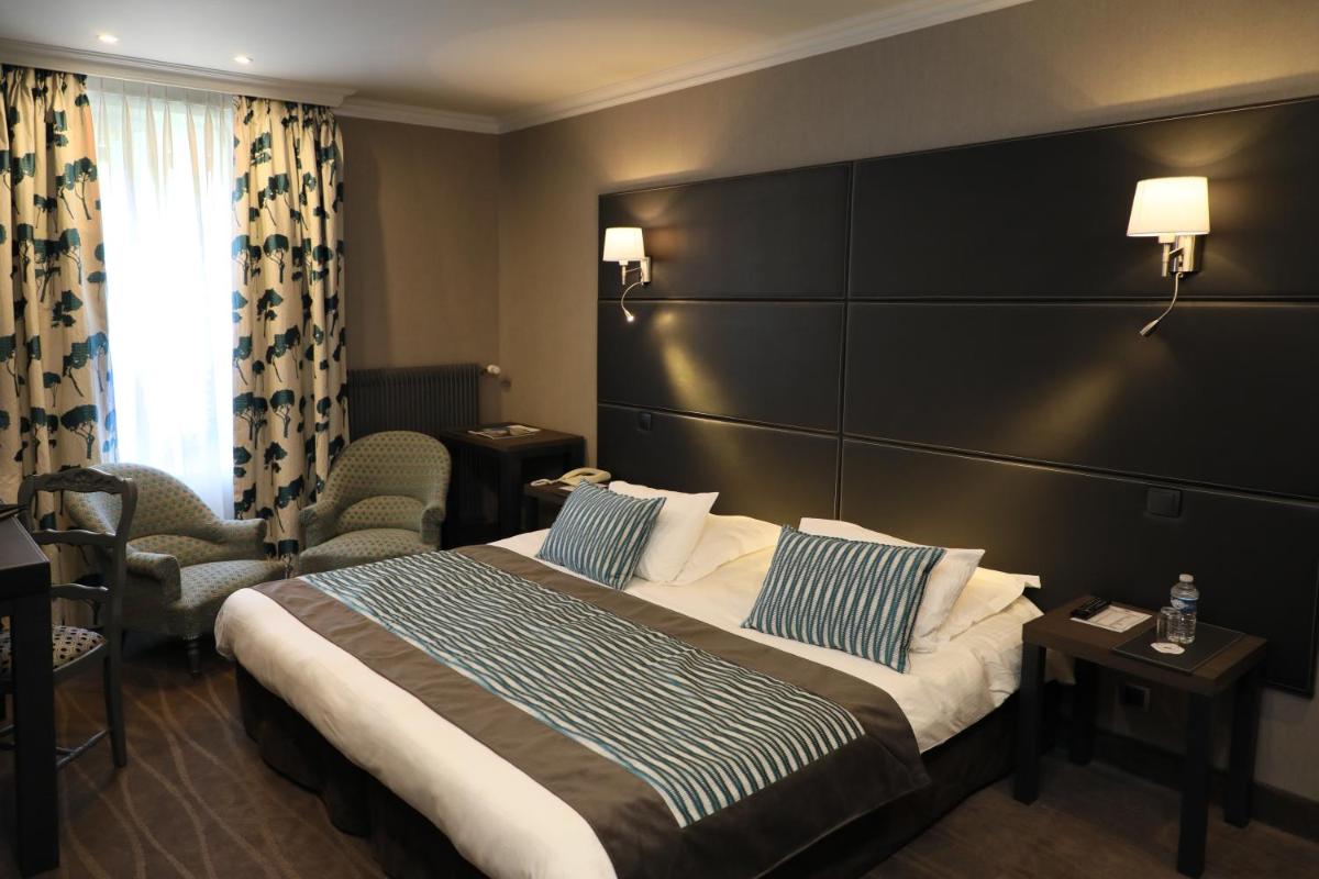 Un ou plusieurs lits dans un hébergement de l'établissement Le Grand Hotel & Spa