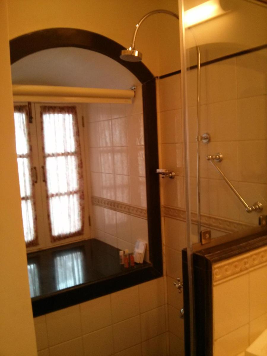 a bathroom with a mirror and a window at Welcomhotel by ITC Hotels, The Savoy, Mussoorie in Mussoorie
