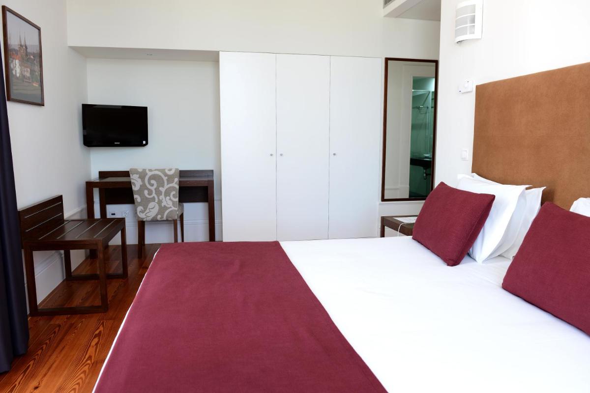 Uma cama ou camas num quarto em Hotel Quinta da Cruz & SPA