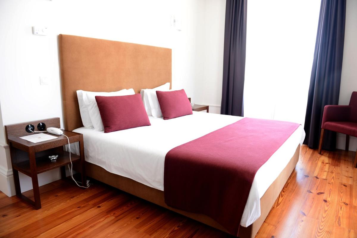 Uma cama ou camas num quarto em Hotel Quinta da Cruz & SPA