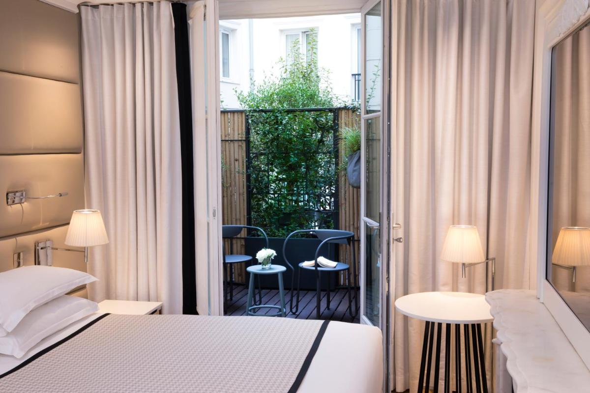 Un ou plusieurs lits dans un hébergement de l'établissement Hôtel R de Paris - Boutique Hotel