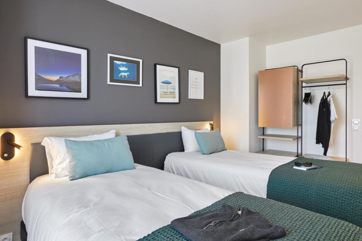 Un ou plusieurs lits dans un hébergement de l'établissement Aparthotel & Spa Adagio Vannes