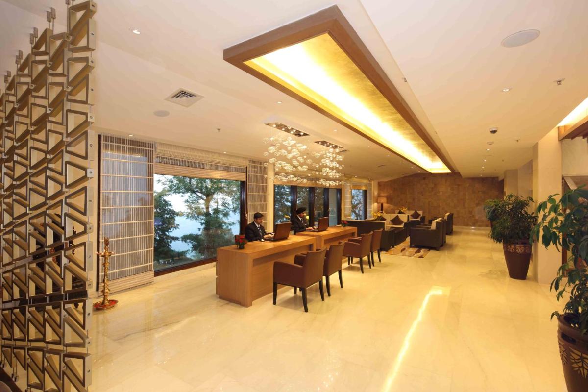 a lobby of a restaurant with tables and chairs at Jaypee Residency Manor in Mussoorie