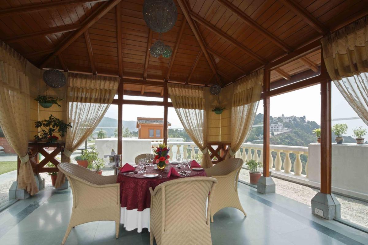 a dining room with a table and chairs at Jaypee Residency Manor in Mussoorie