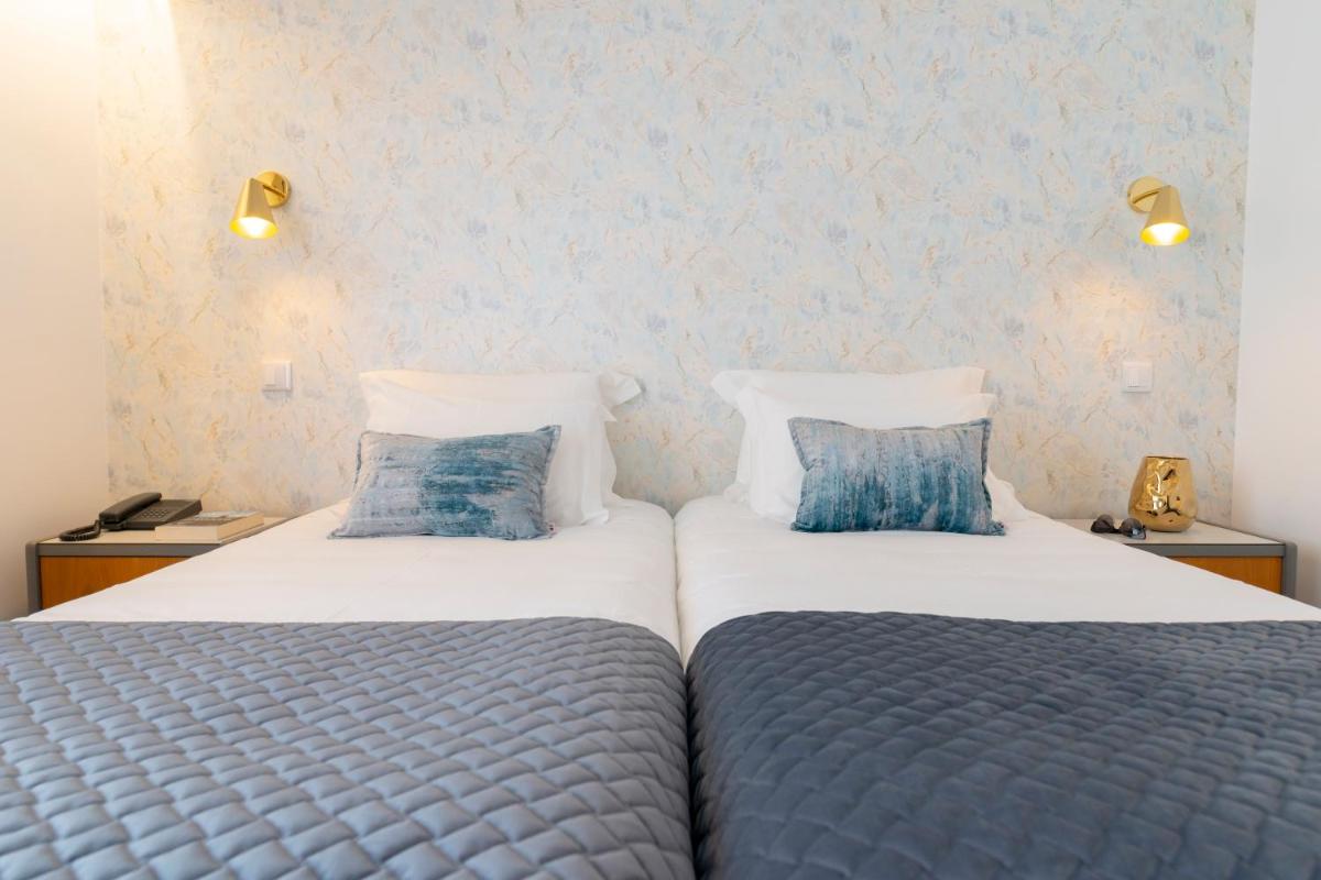 Uma cama ou camas num quarto em D. Afonso Hotel & SPA