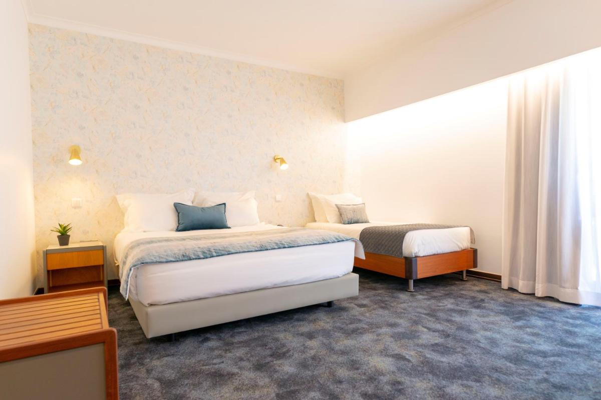 Uma cama ou camas num quarto em D. Afonso Hotel & SPA