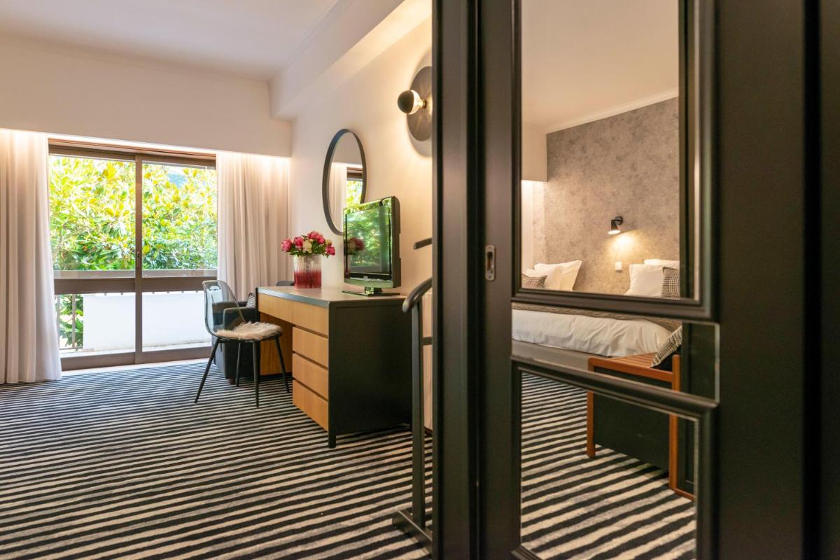 Uma cama ou camas num quarto em D. Afonso Hotel & SPA