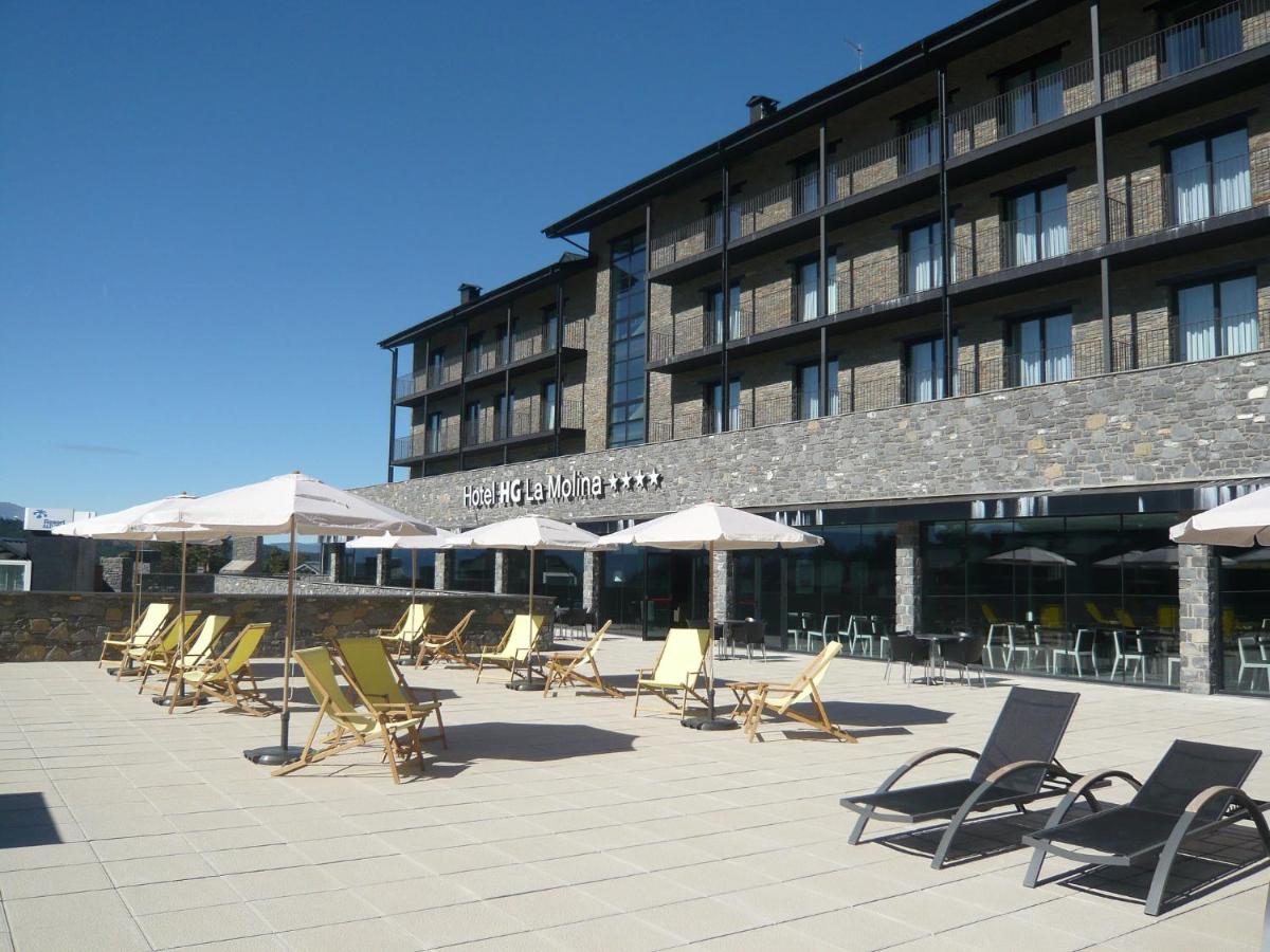 una fila de sillas y sombrillas frente a un edificio en HG La Molina, en La Molina