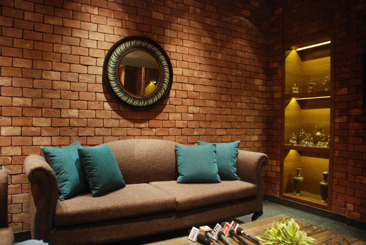 a living room with a couch and a mirror at The Lalit Great Eastern Kolkata in Kolkata a living room with a couch and a mirror at The Lalit Great Eastern Kolkata in Kolkata