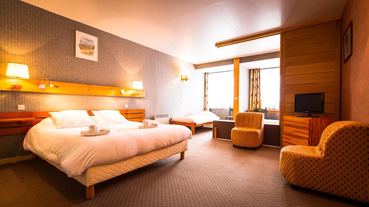 Un ou plusieurs lits dans un hébergement de l'établissement Hôtel Restaurant Saint Roch