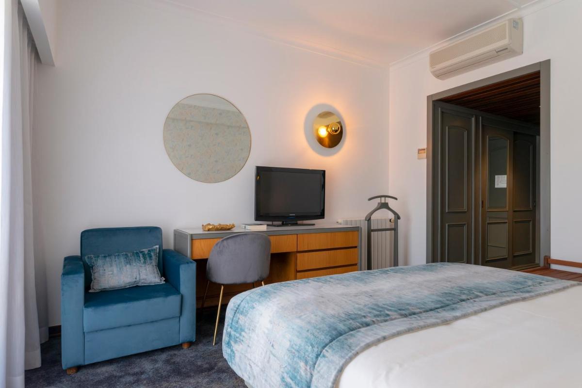 Uma cama ou camas num quarto em D. Afonso Hotel & SPA
