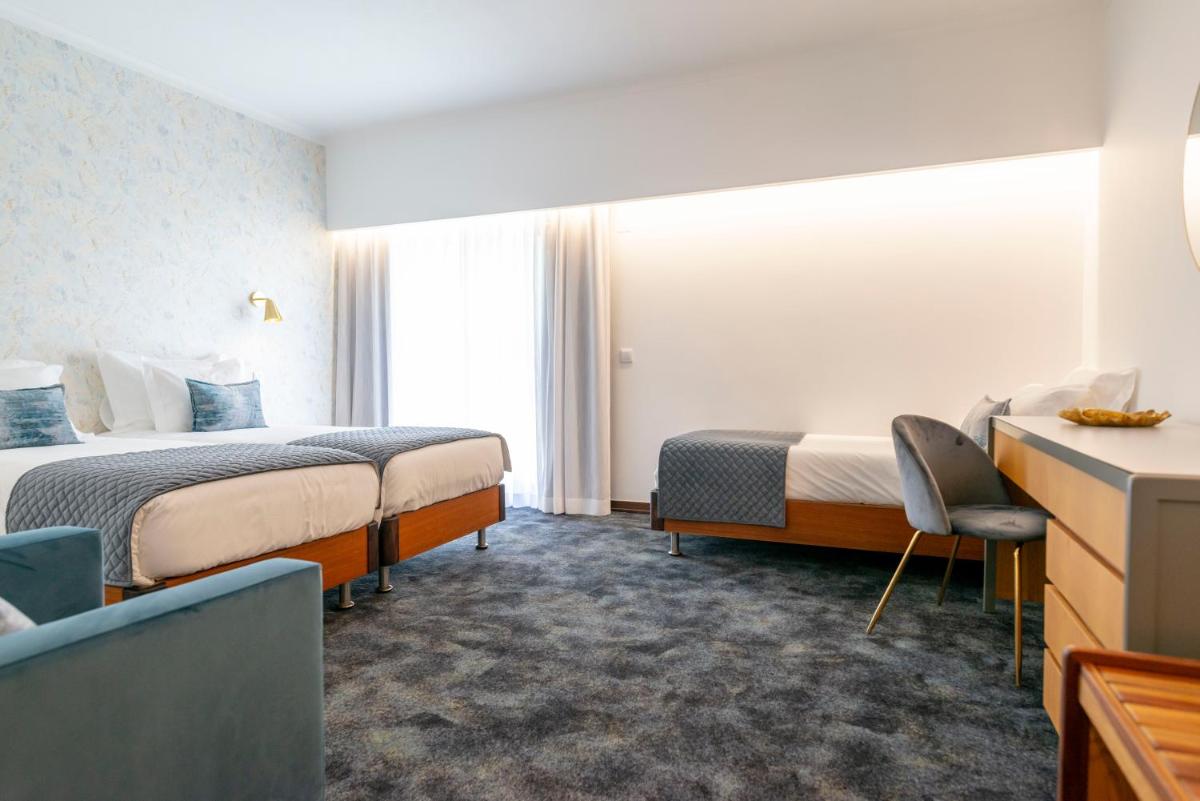 Uma cama ou camas num quarto em D. Afonso Hotel & SPA
