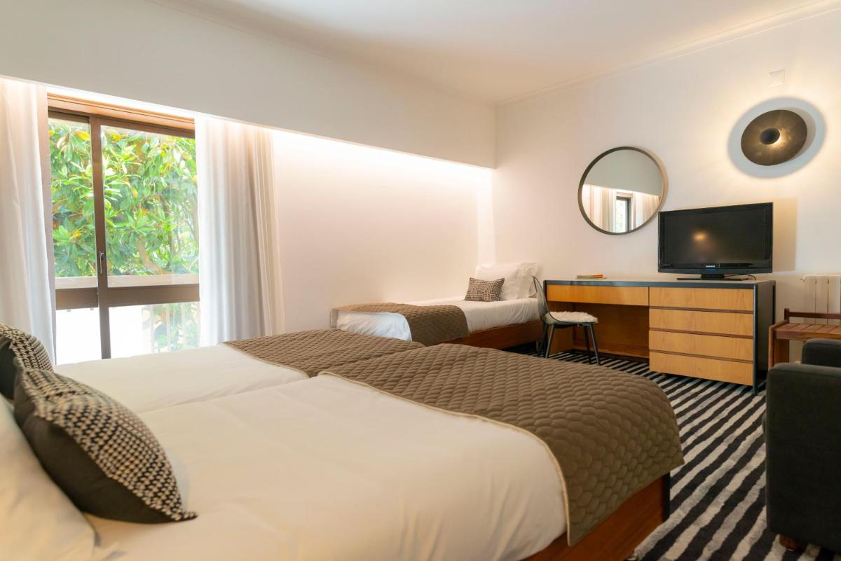 Uma cama ou camas num quarto em D. Afonso Hotel & SPA
