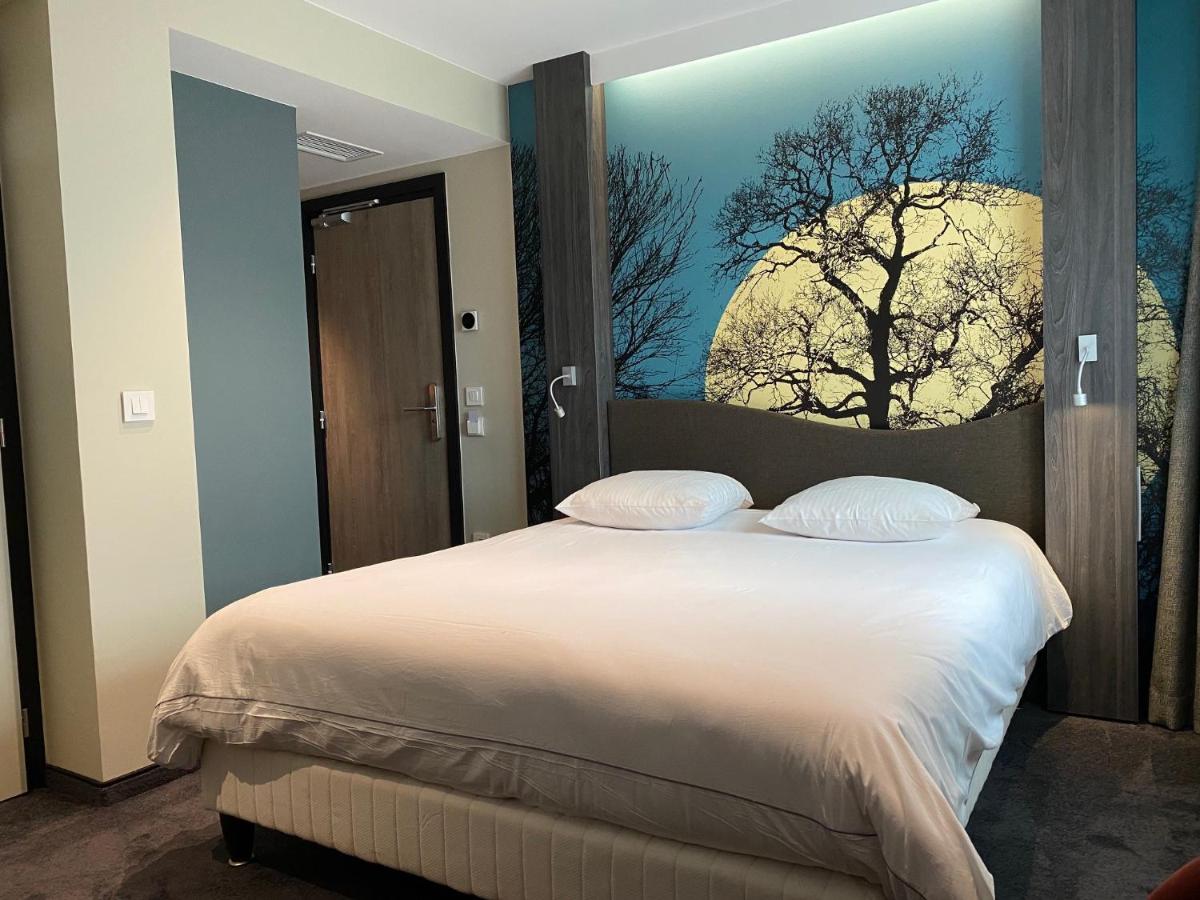 Un ou plusieurs lits dans un hébergement de l'établissement Au Soleil, Hôtel Restaurant & Spa