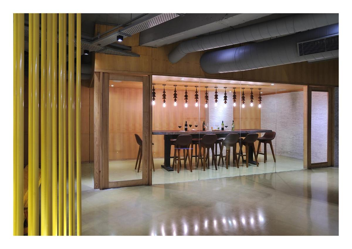 a dining room with a long table and chairs at The Anya Hotel-Golf Course Road in Gurgaon