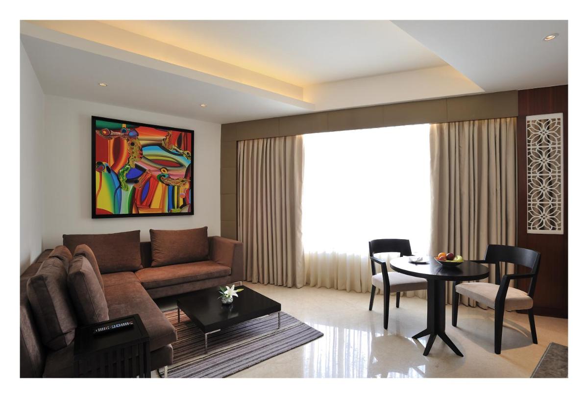 a living room with a couch and a table at The Anya Hotel-Golf Course Road in Gurgaon