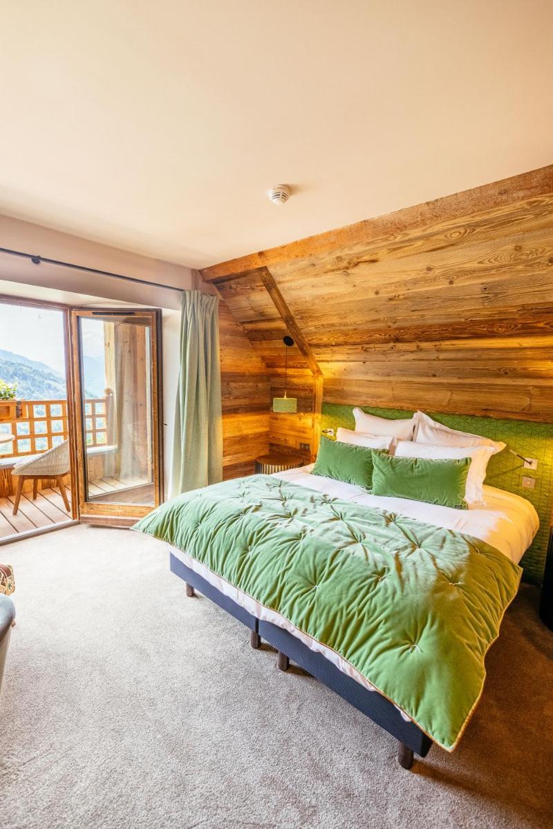Un ou plusieurs lits dans un hébergement de l'établissement Hotel Le V de Vaujany