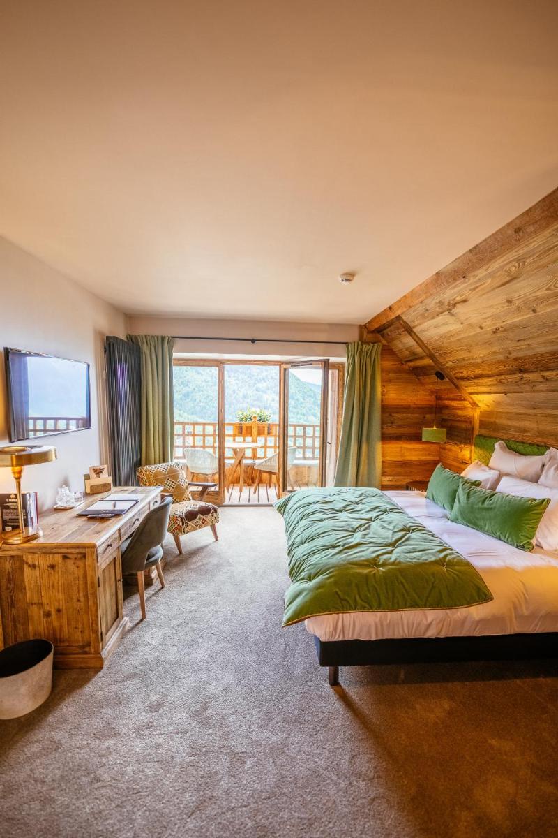 Un ou plusieurs lits dans un hébergement de l'établissement Hotel Le V de Vaujany