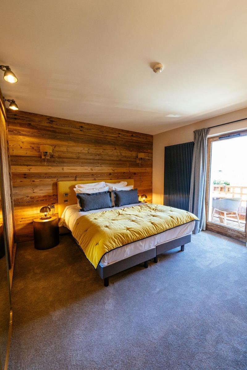 Un ou plusieurs lits dans un hébergement de l'établissement Hotel Le V de Vaujany