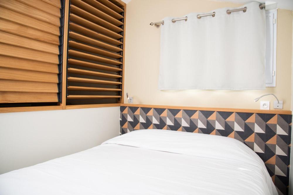 Un ou plusieurs lits dans un hébergement de l'établissement Hotel Les Dunes