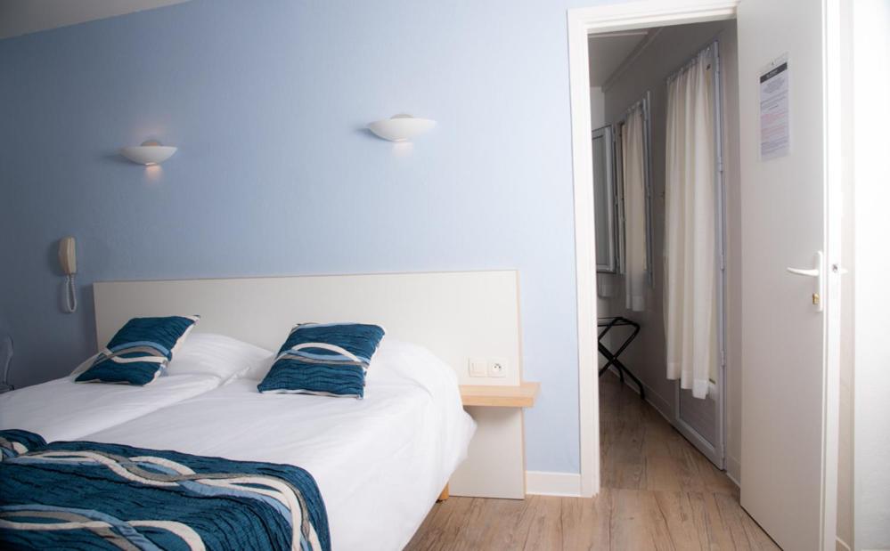 Un ou plusieurs lits dans un hébergement de l'établissement Hotel Les Dunes