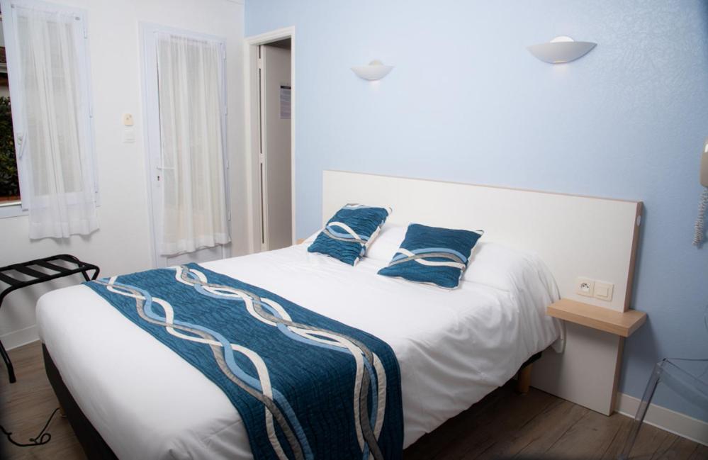 Un ou plusieurs lits dans un hébergement de l'établissement Hotel Les Dunes