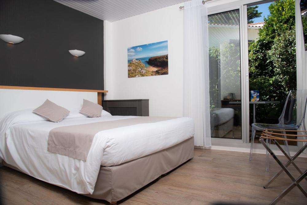 Un ou plusieurs lits dans un hébergement de l'établissement Hotel Les Dunes