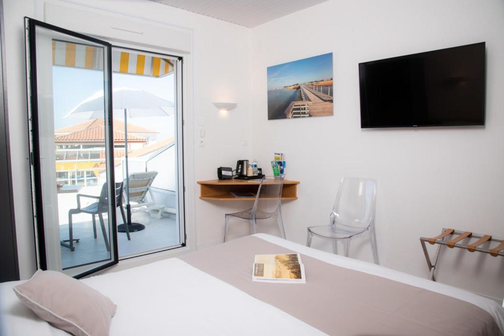 Un ou plusieurs lits dans un hébergement de l'établissement Hotel Les Dunes